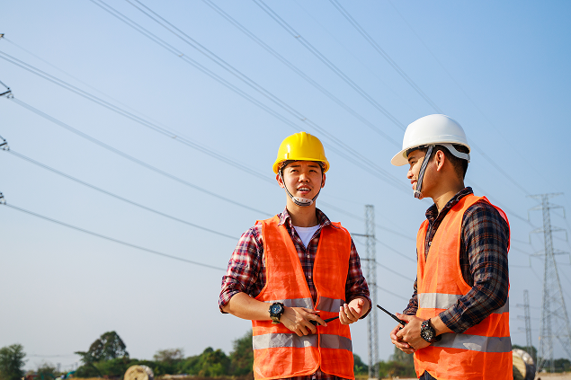 Construction Workers in Safety Gear Discussing Project
