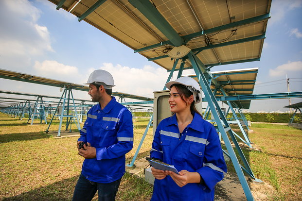 Solar Panel Technicians at Array Site Inspecting Panels