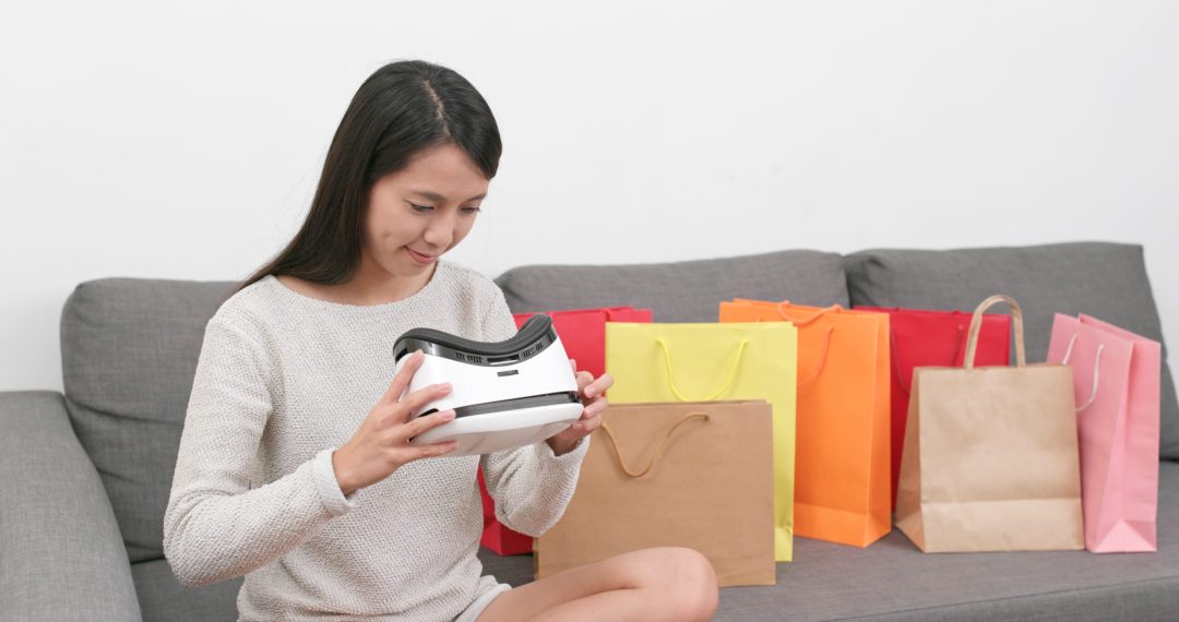 Woman using virtual reality device for shopping experience at home