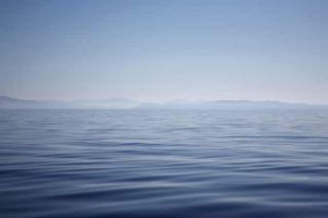 Ocean with mountains on horizon