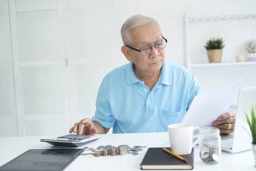 serious-man-sitting-at-table-near-utility-bill-and-2022-04-07-00-39-54-utc-min