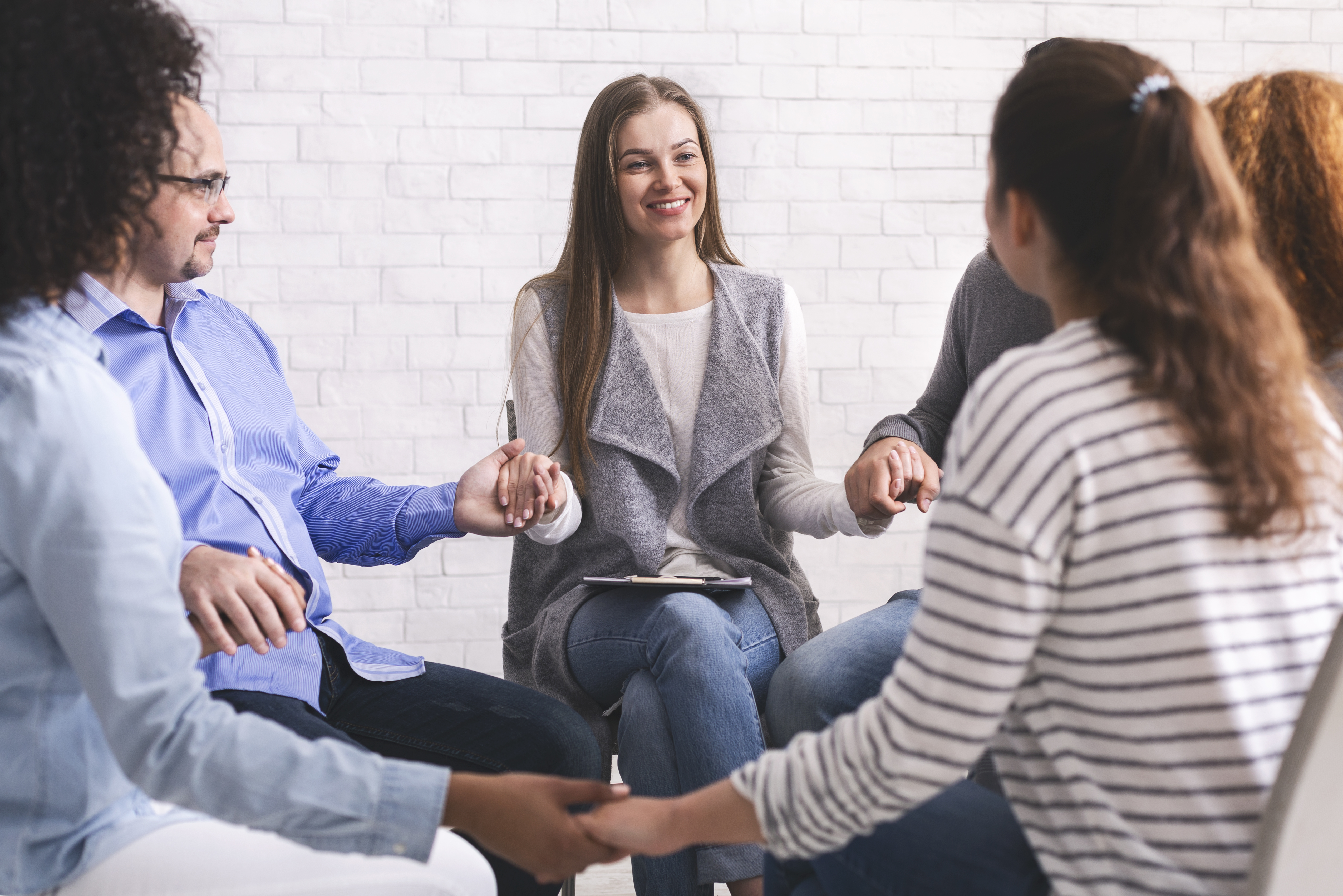 group-of-addicted-people-holding-hands-sitting-in-2022-12-16-09-00-11-utc